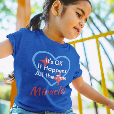 Bella+Canvas toddler t-shirt with “Miracles Happen” design and uplifting message, soft cotton, breathable and durable, Christian apparel for everyday wear and family matching, toddler girl in blue t-shirt